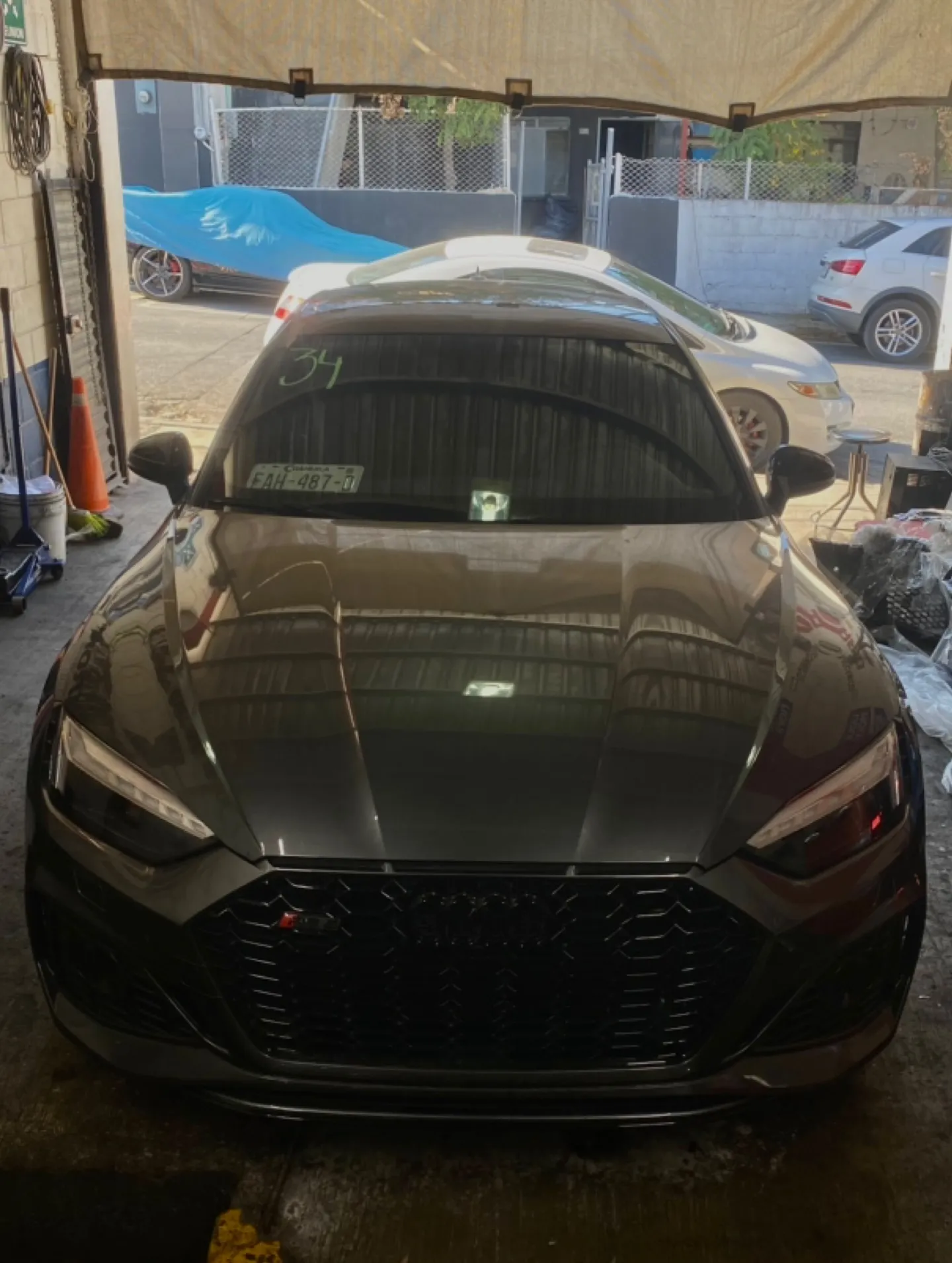 Audi oscuro visto de frente dentro del taller